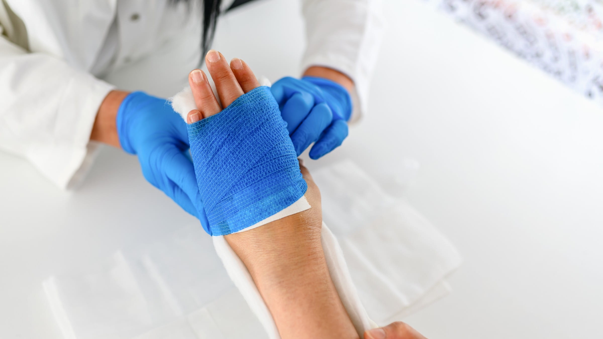 Doctor bandaging a patient's arm