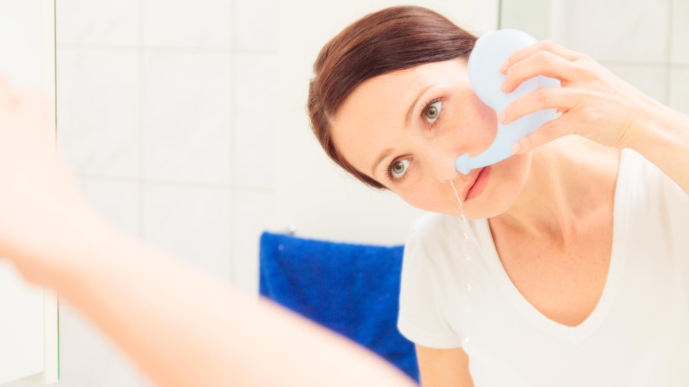 Woman rinsing her nose with neti pot