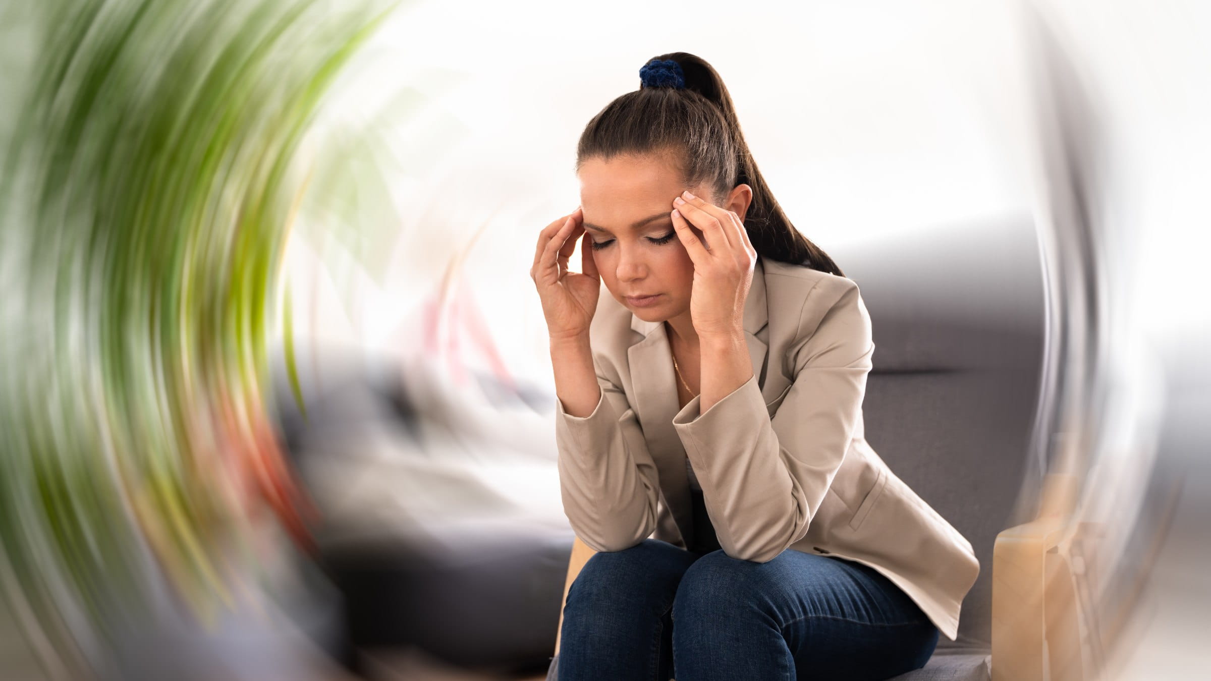 Woman holding her head dizzy with vertigo