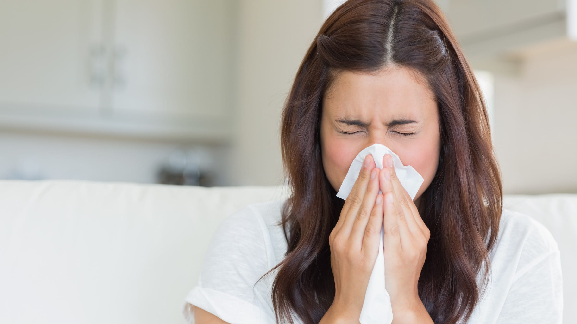 Woman blowing her nose