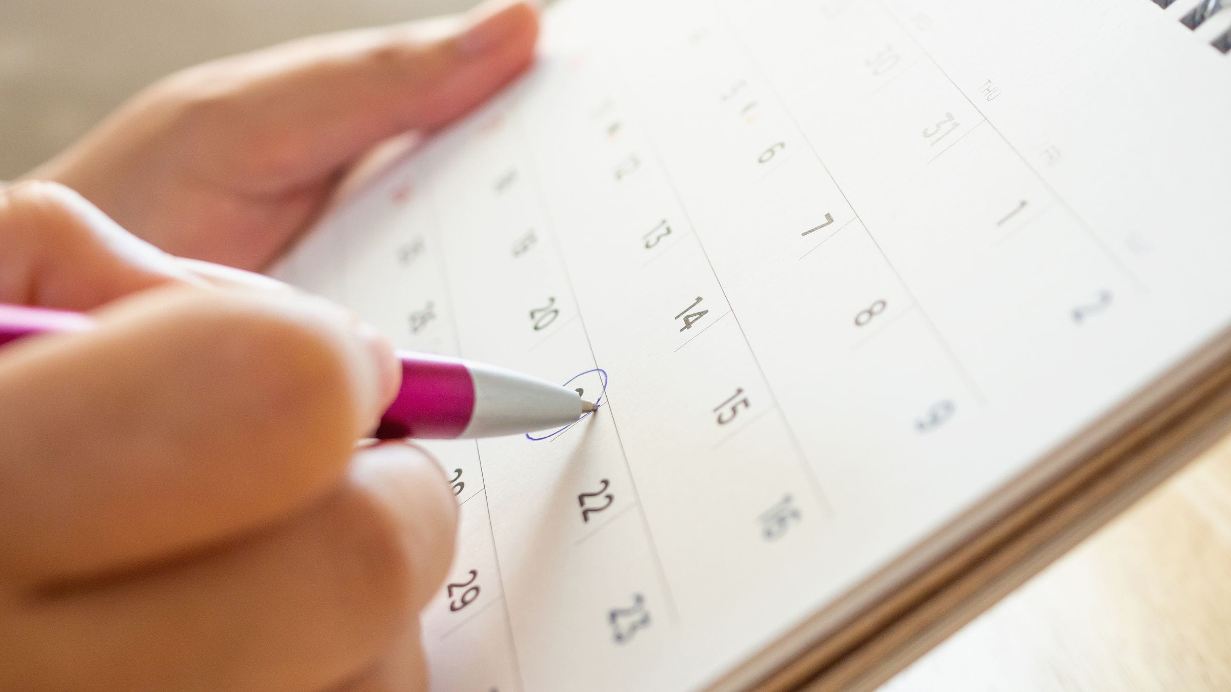 Woman circling a day in a calendar