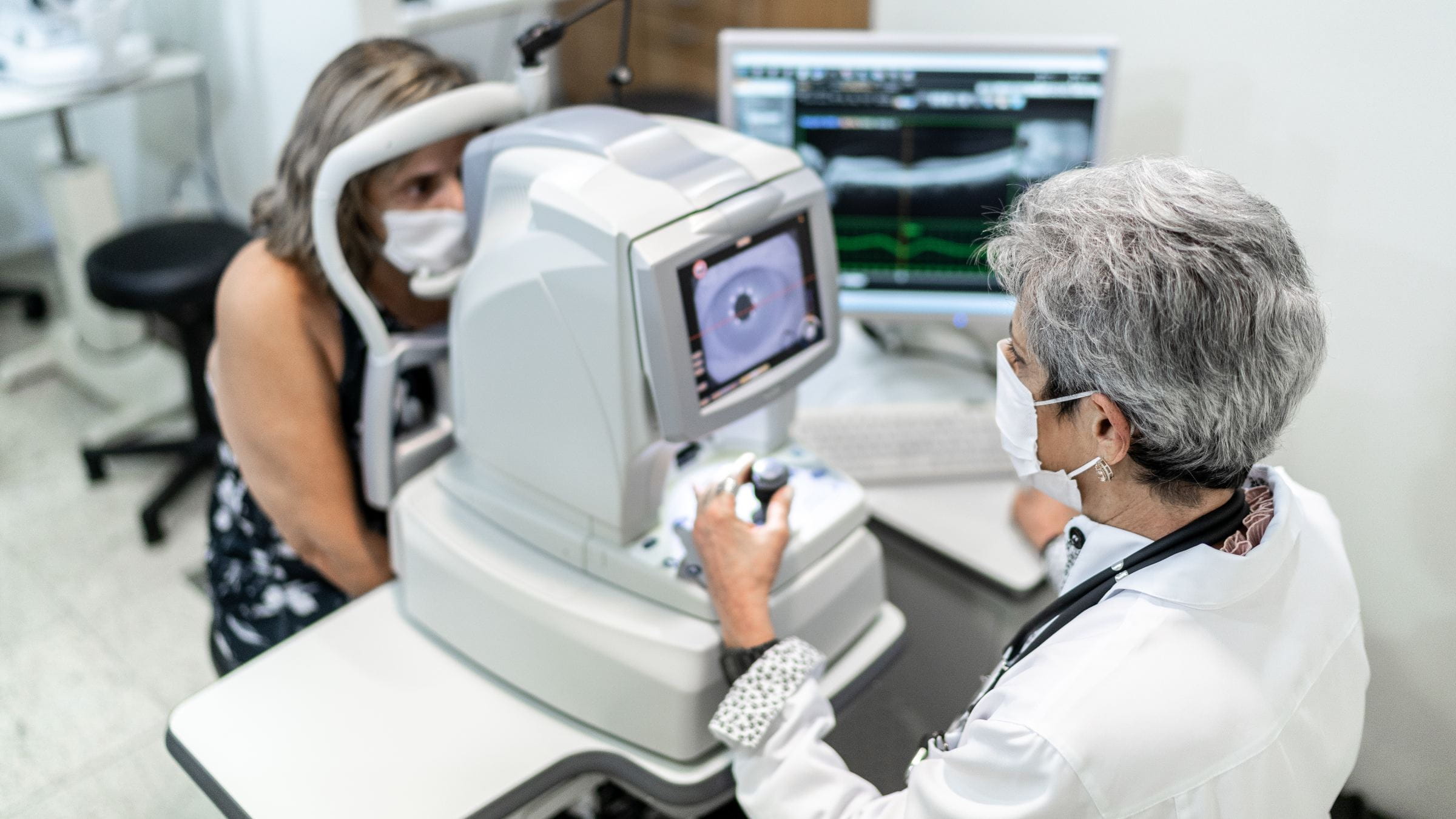 Senior woman having her eyes examined at the optometrist