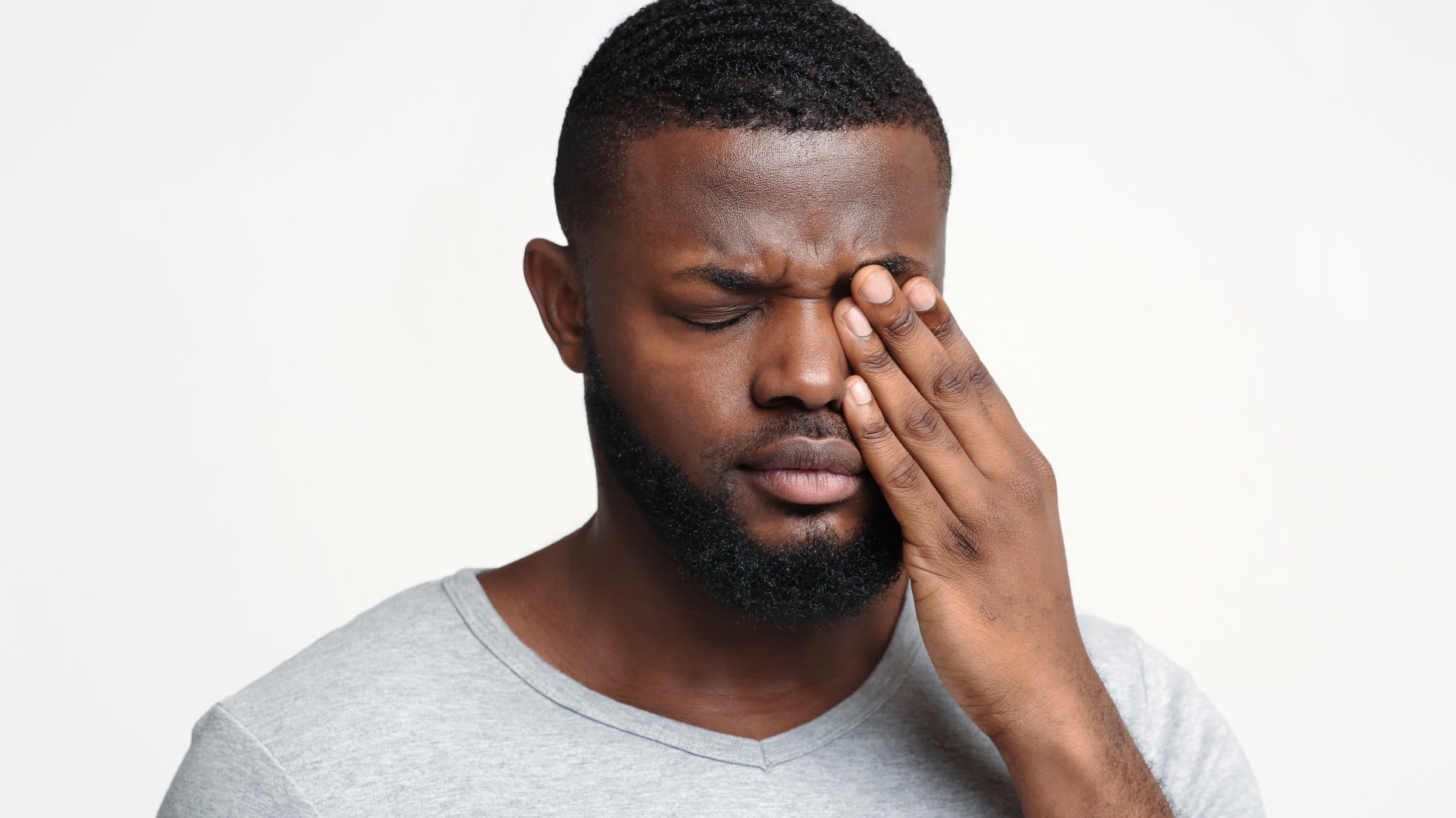 Man touching his eye