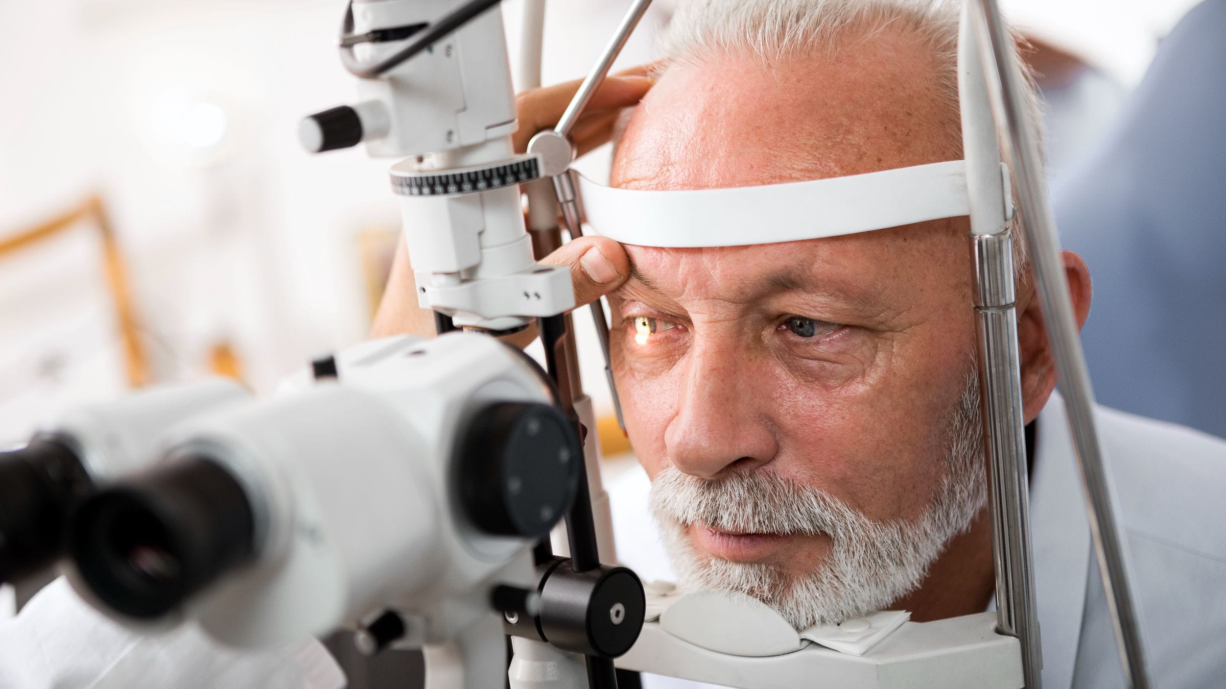 Optometrist checking patient's eyes for glaucoma