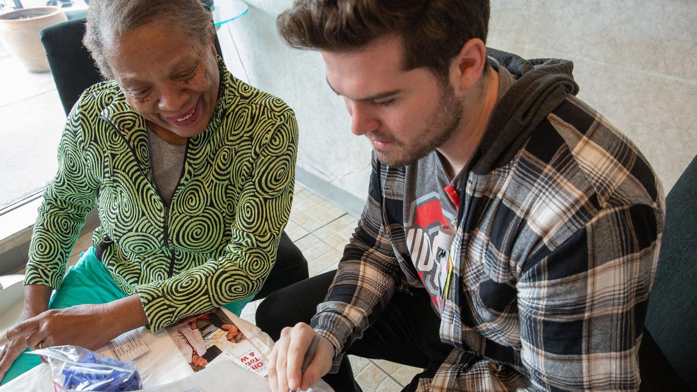 OSU nursing student working with an elderly African American woman