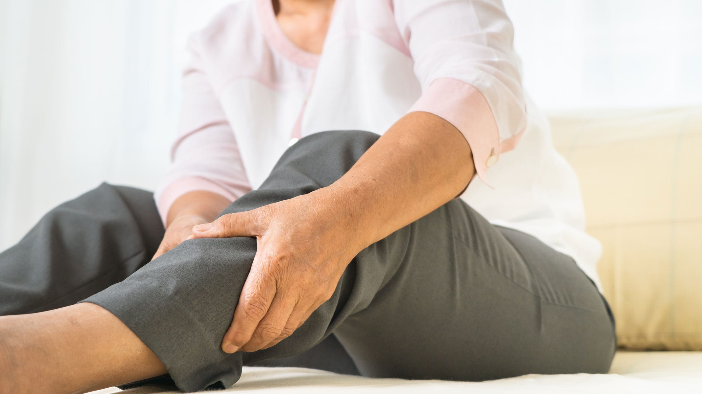 Woman grabbing her leg in pain