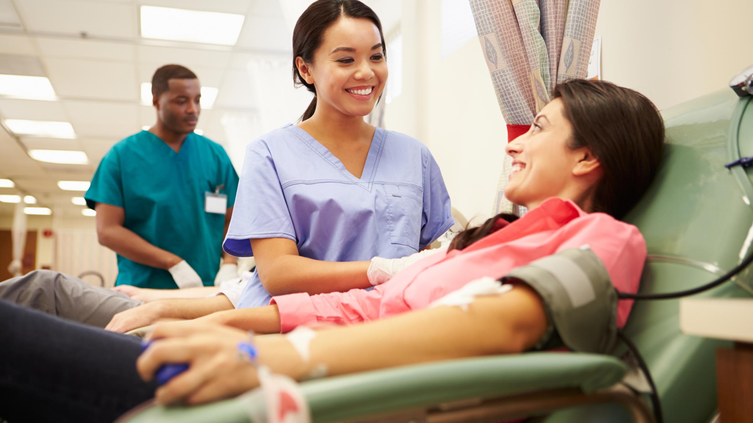 Woman interacting with a nurse while donating blood