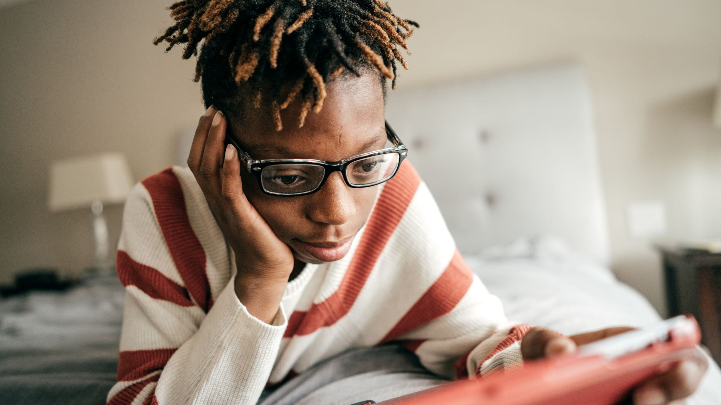 Teen boy looking at his tablet