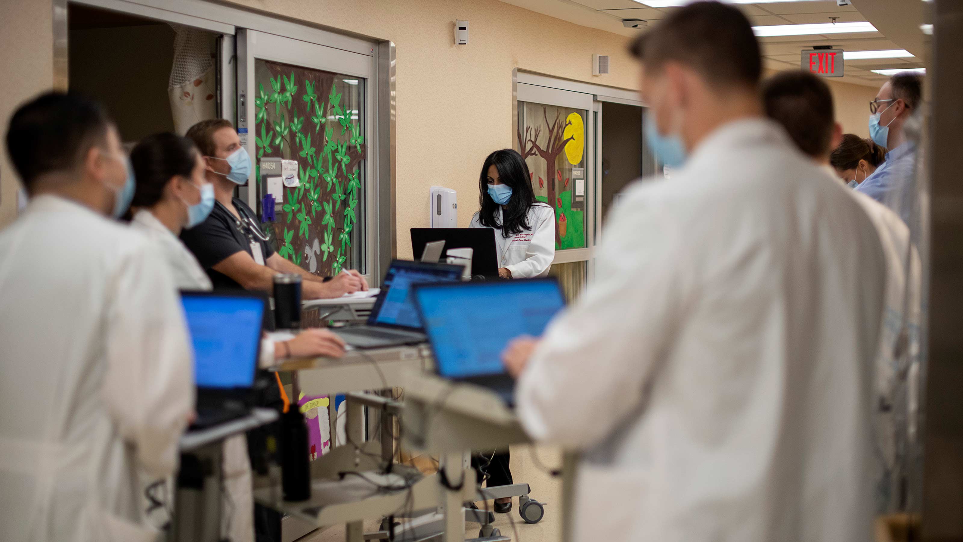 A team of Ohio State doctors and nurses gather outside of a patients room