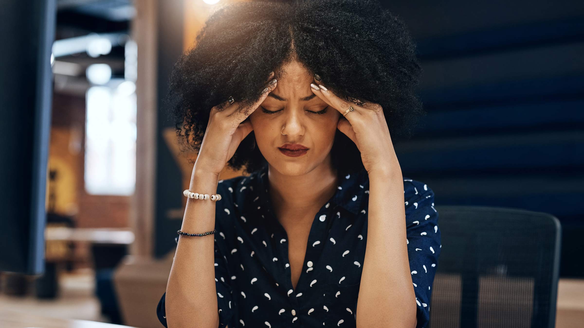 Woman with hands on her head