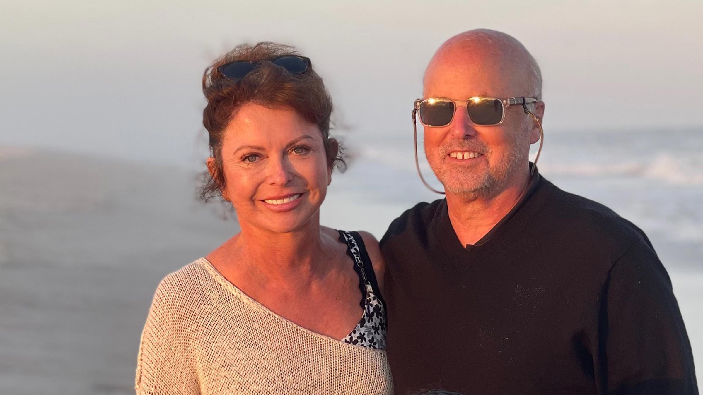 Philip Knisely on the beach with his wife