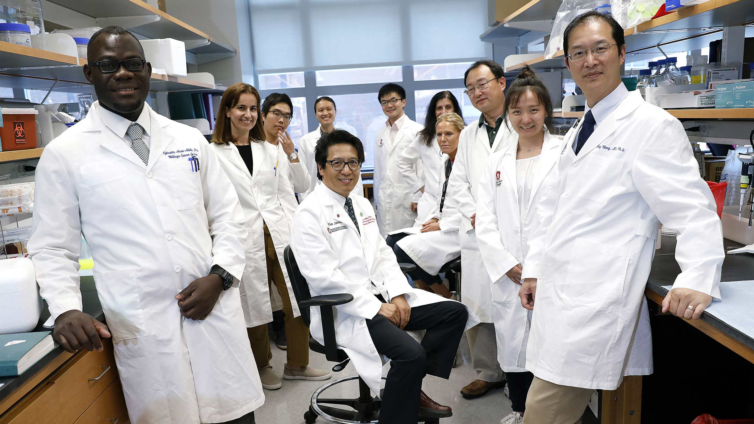 Zihai Li, MD, PhD, founding director of the Pelotonia Institute for Immuno-Oncology (PIIO), meets with research colleagues in a PIIO lab