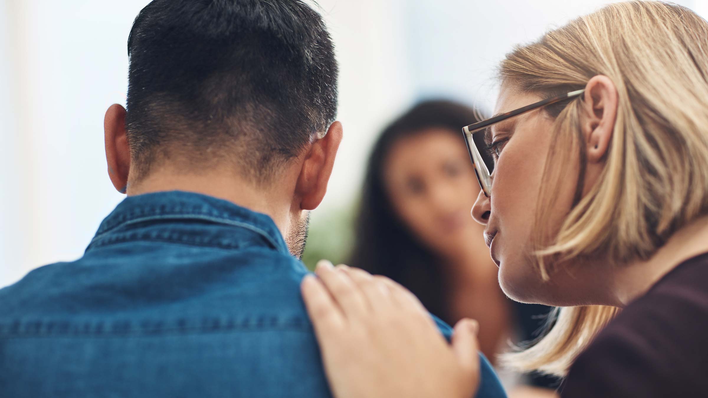 Woman with her hand on a mans shoulder