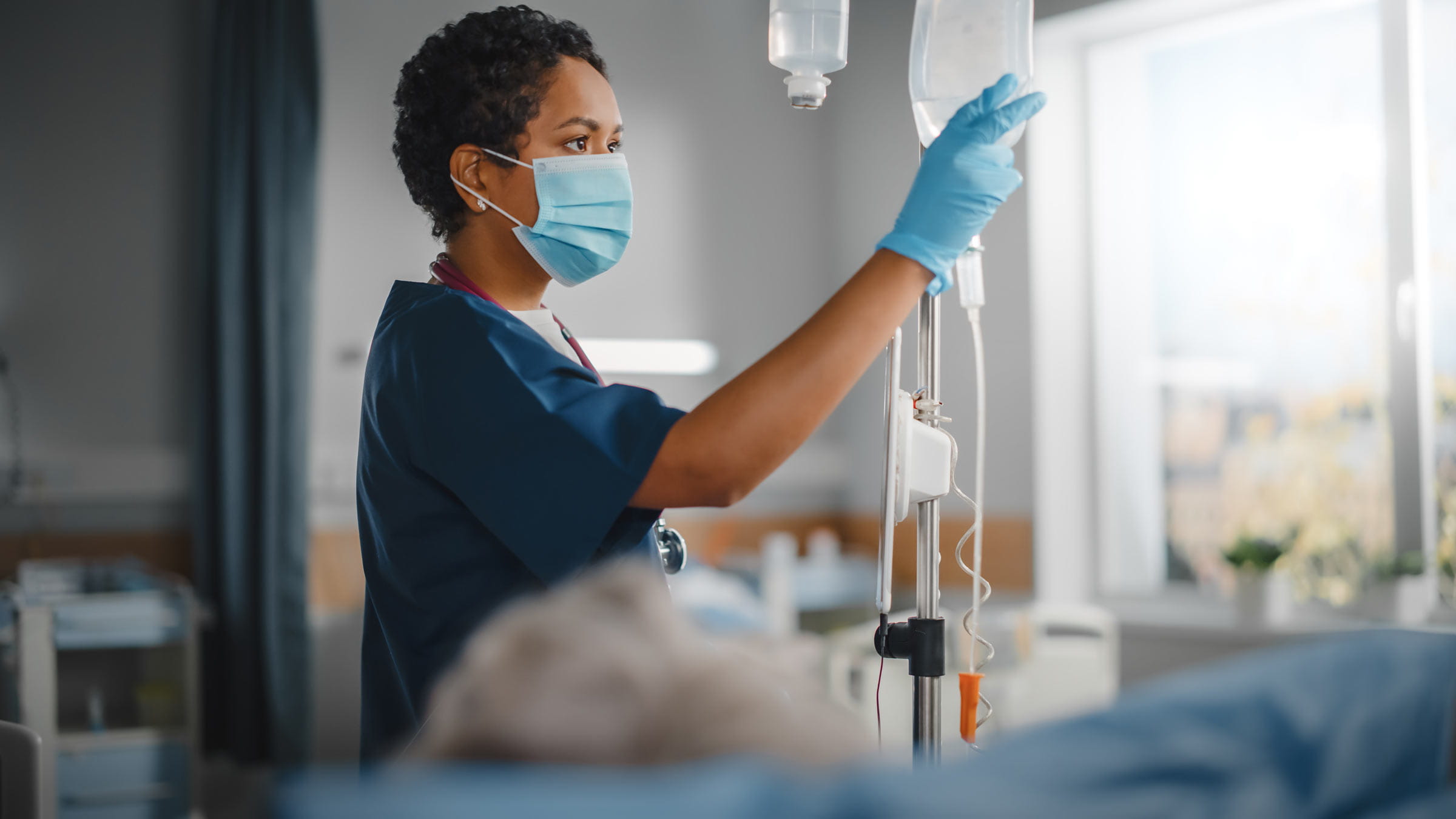 Nurse attending to IV bag