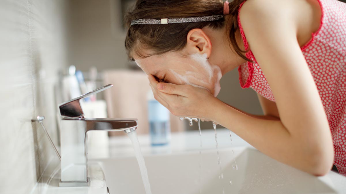 Girl washing her face