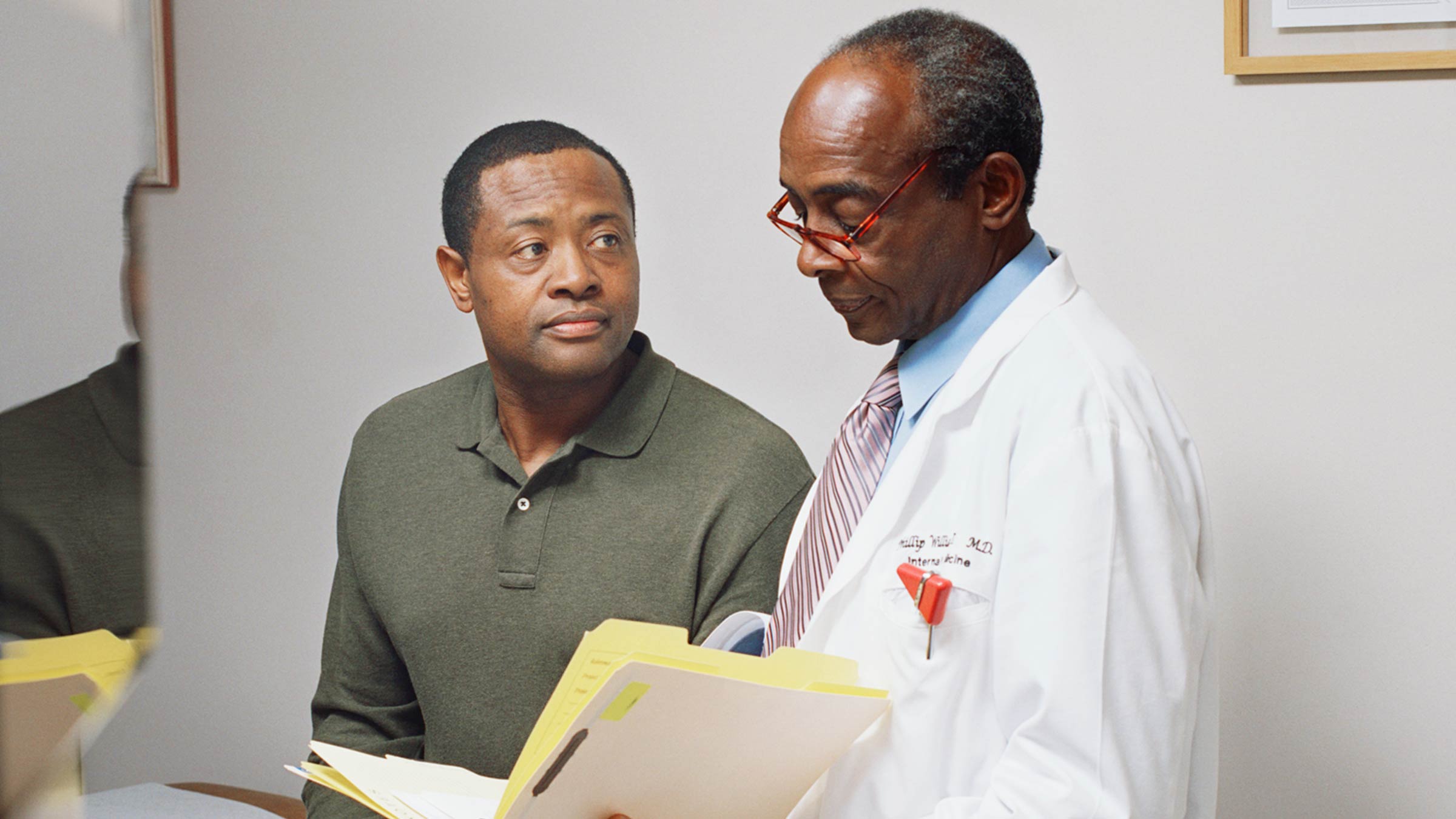 Doctor reviewing a chart with a middle aged man