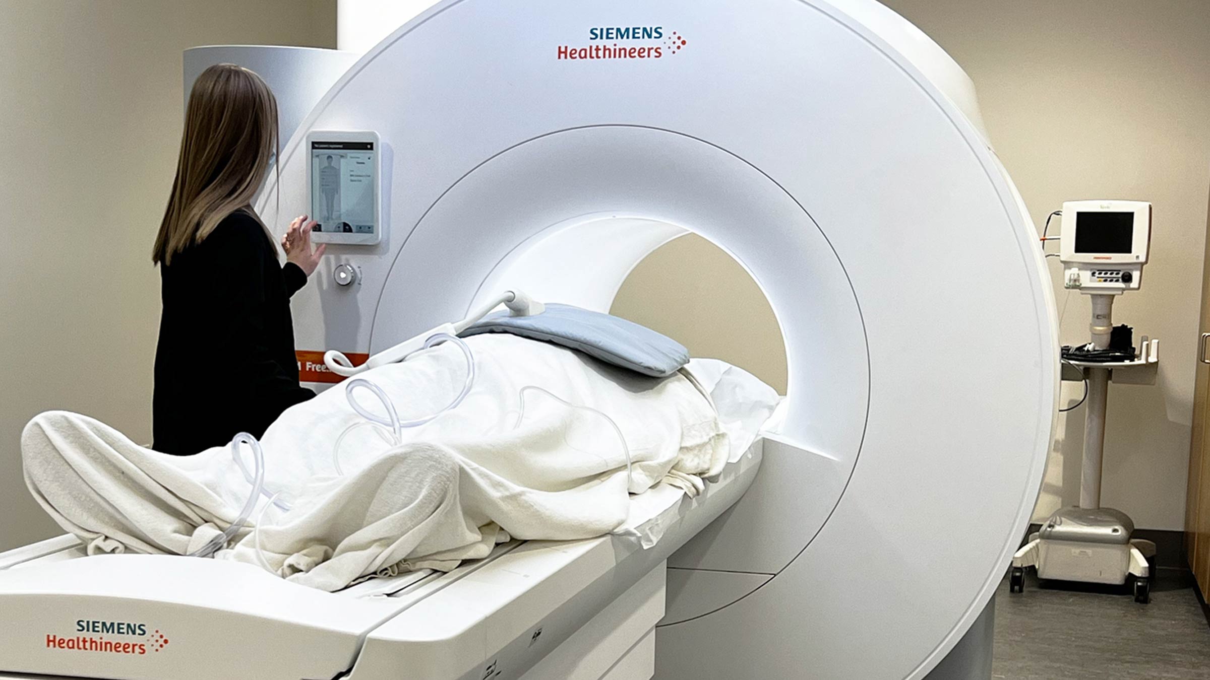 Technician preparing a patient for a cardiac MRI