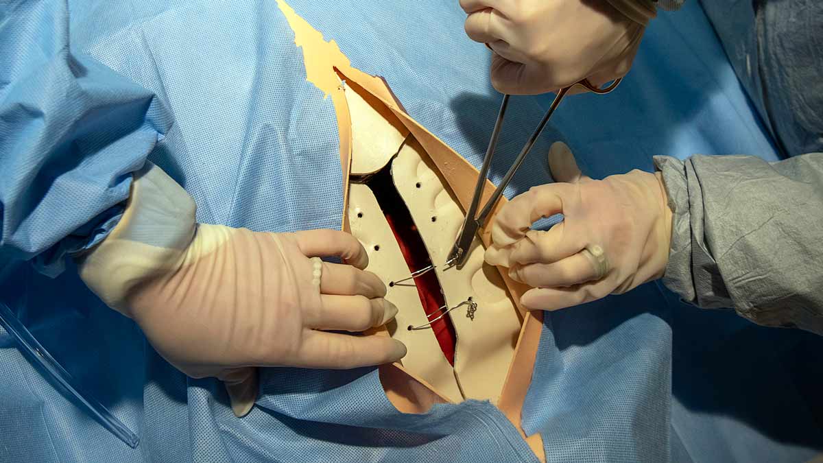 Nurses practicing to undo the wires binding a patient’s sternum