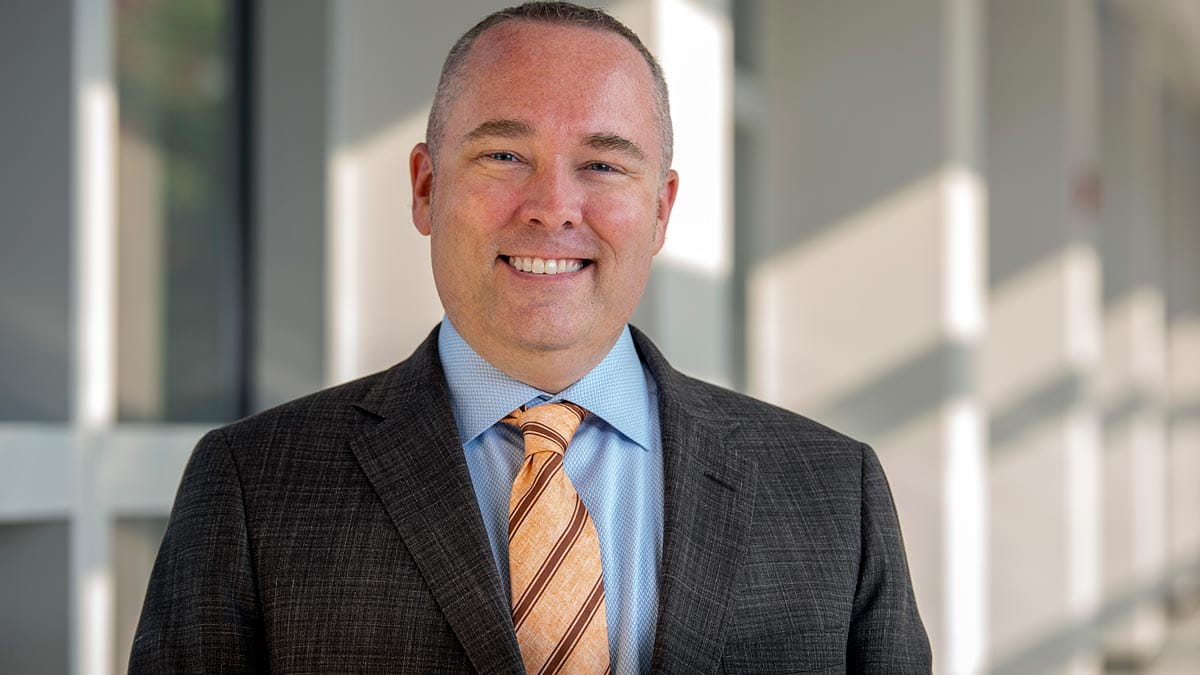 Craig Bryan wearing in a suit and smiling