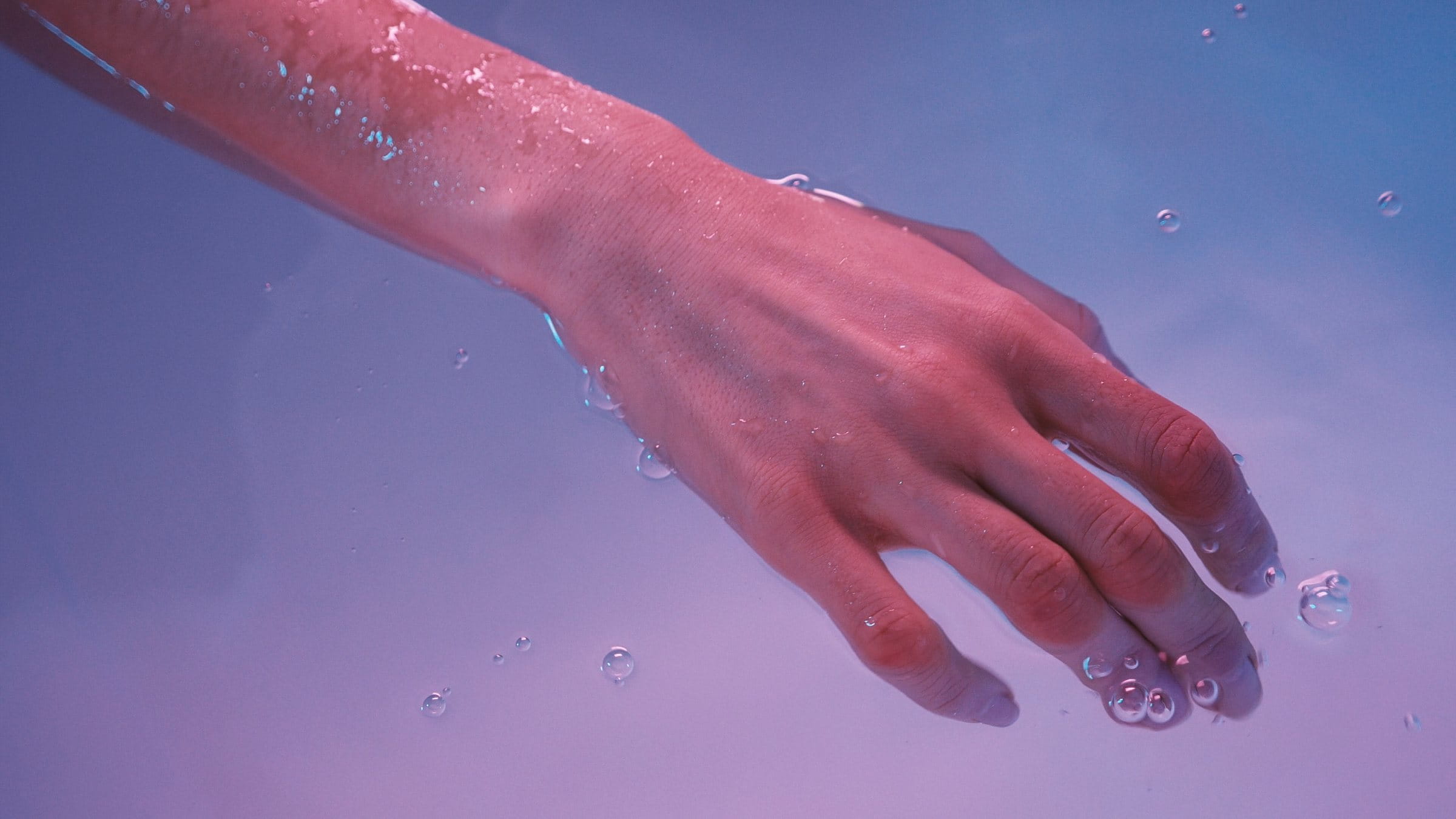 Young woman's hand floating in spa bath