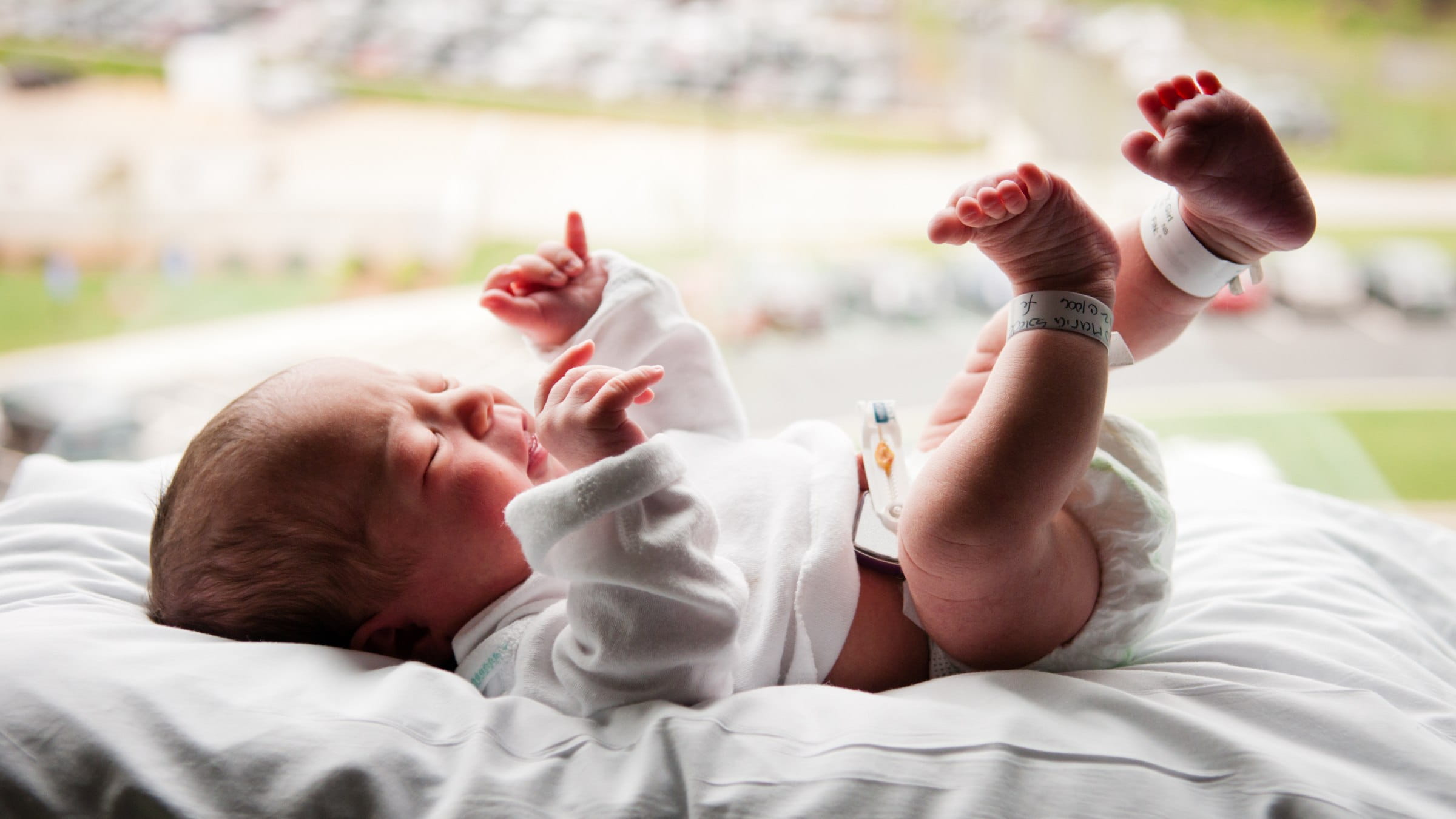 Baby lying by the window in a hospital room