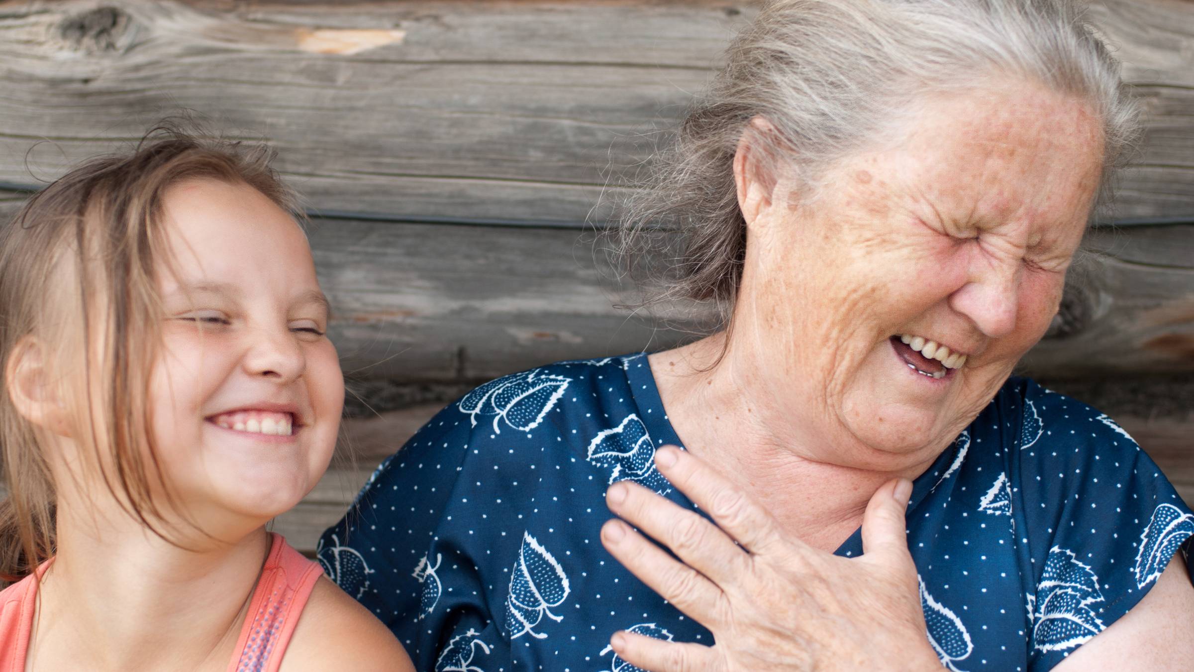 Elderly woman laughing with her granddaughter