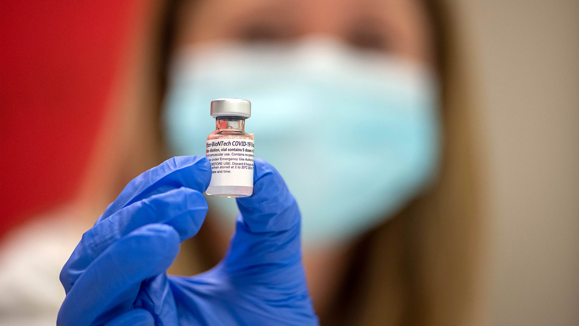 Close-up view of a healthcare worker holder a Pfizer vaccine vile