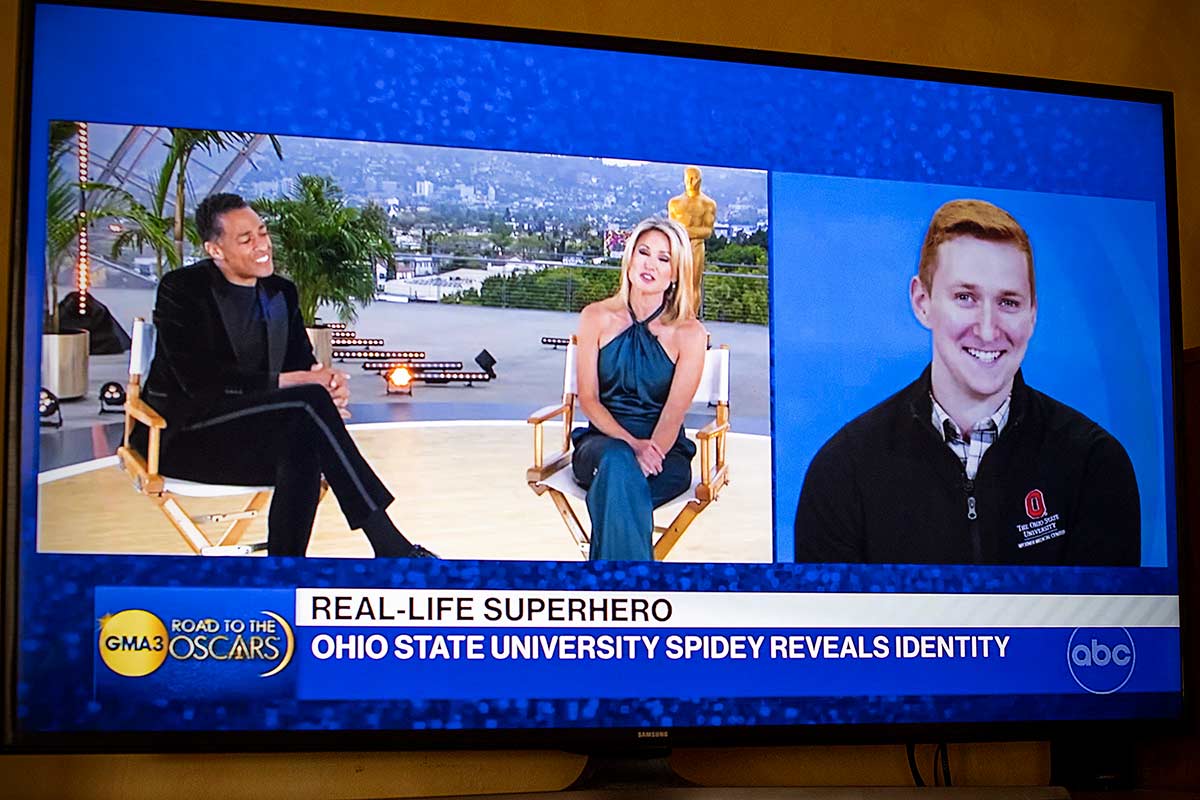 A TV screen with “Good Morning America” hosts and Phil Re