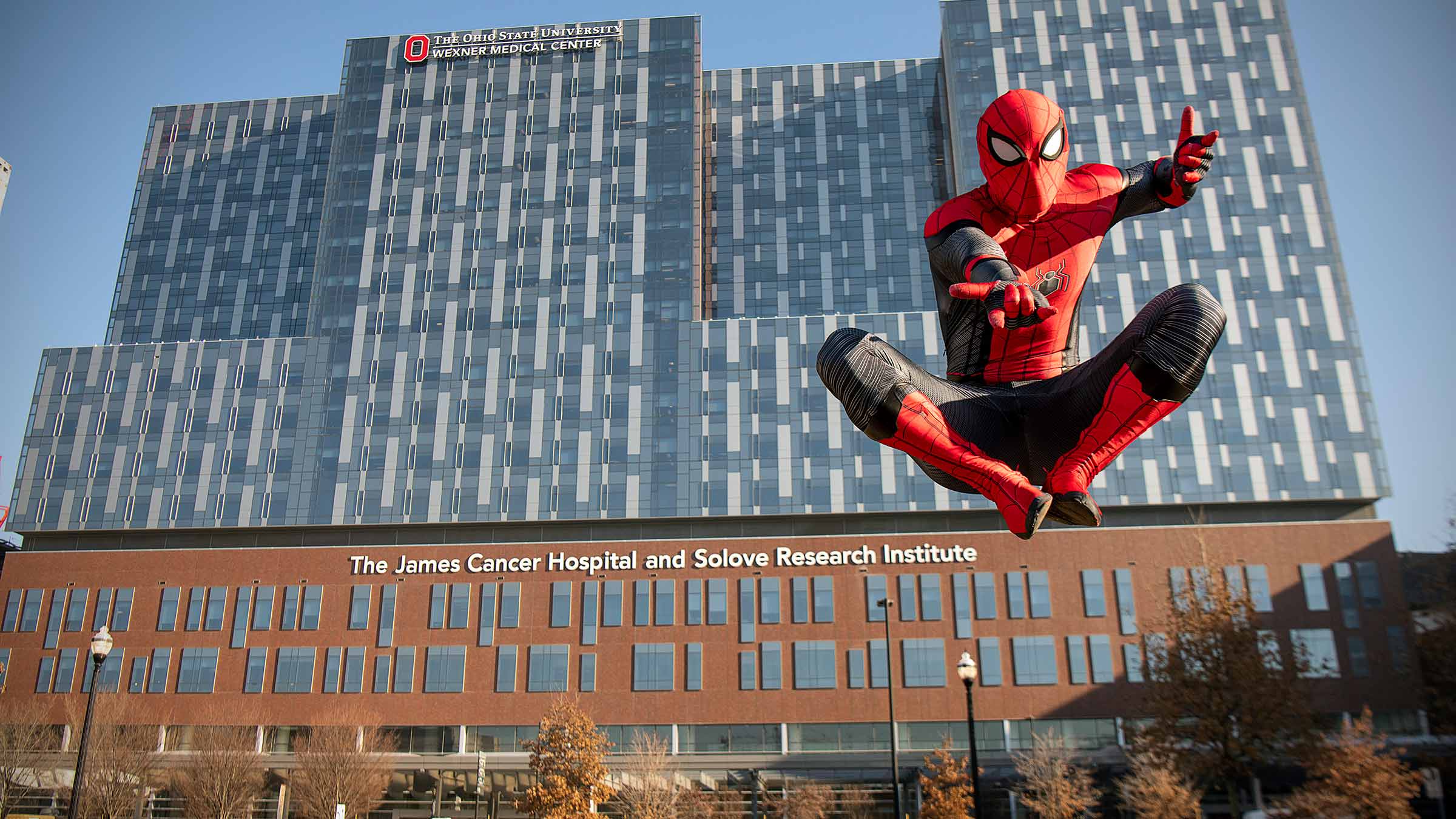 Spider-Man in a jump with the OSUCCC – James building on the background