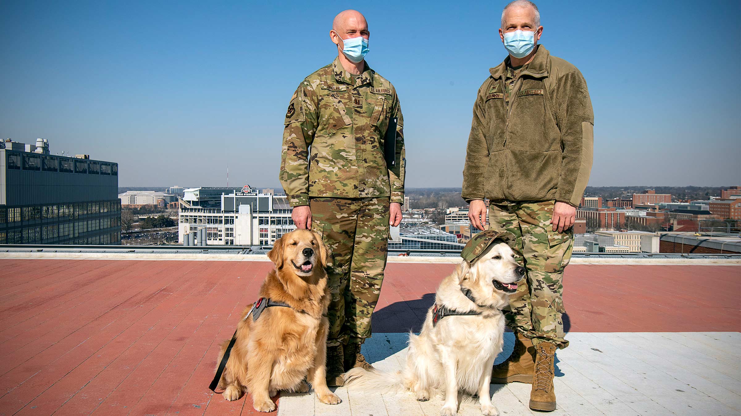 Buckeye Paws dogs with members of the Air Force on the helipad at the medical center
