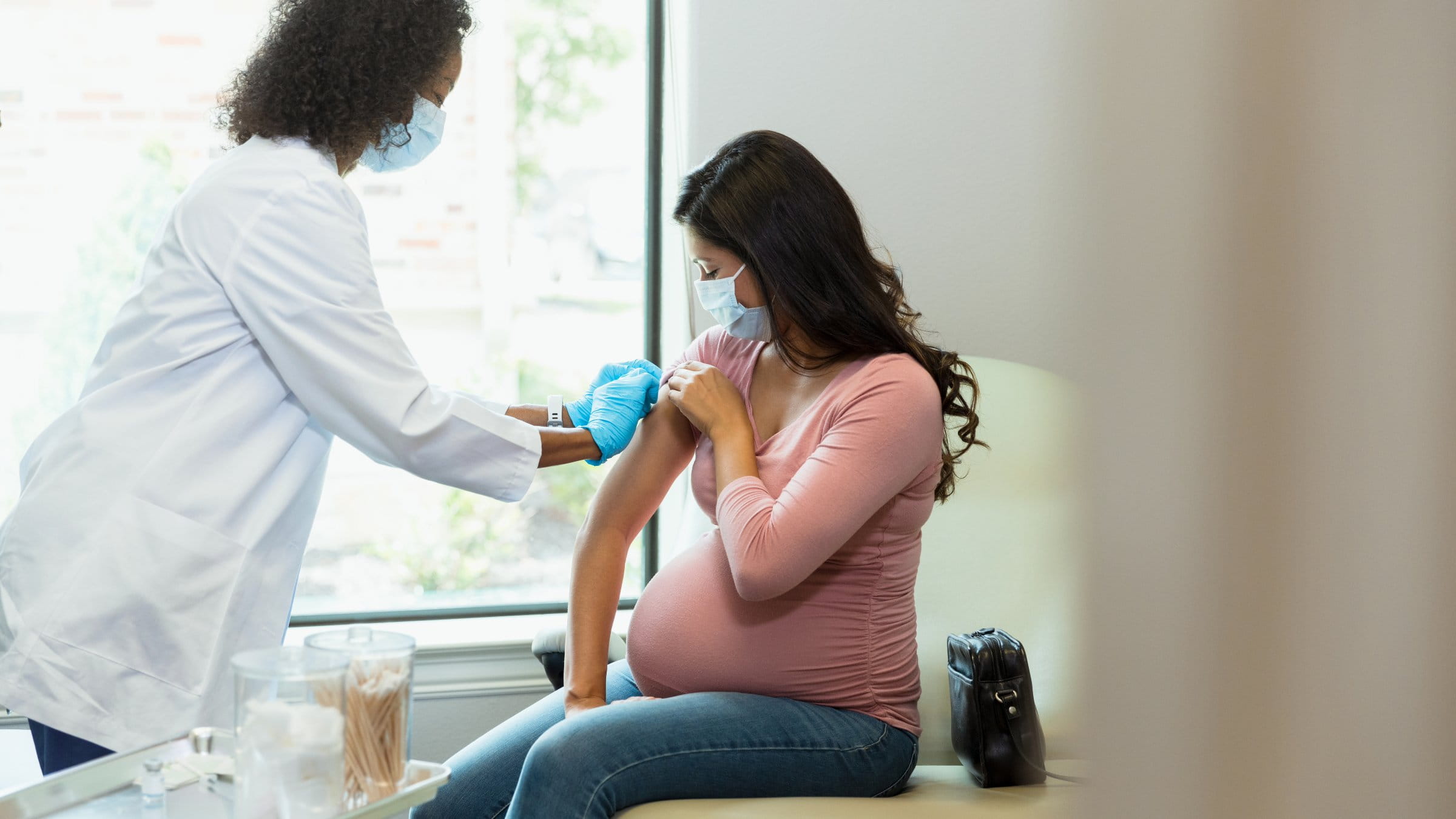 Pregnant woman getting administered a vaccine