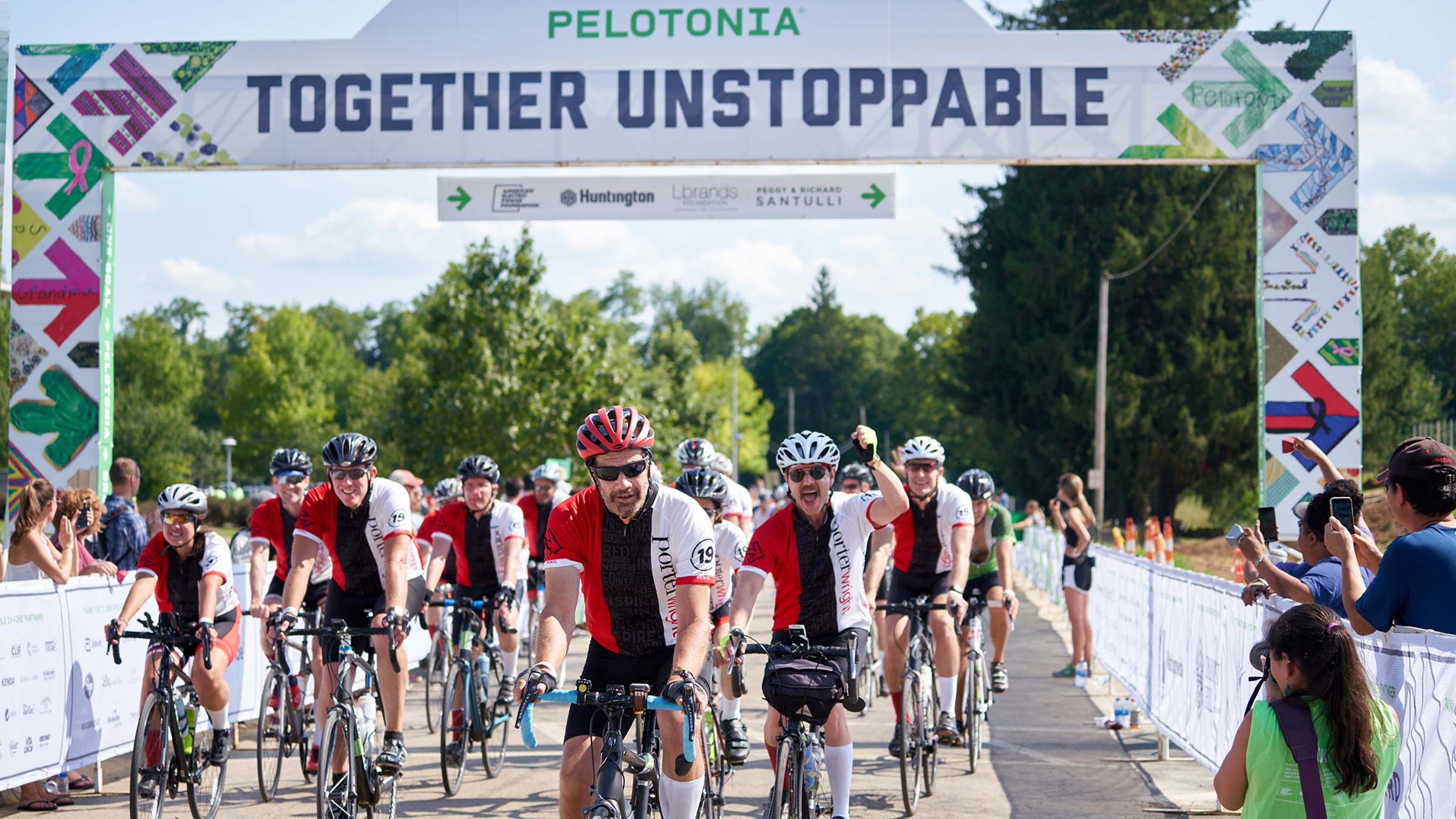 Cyclists riding over the finish line at Pelotonia