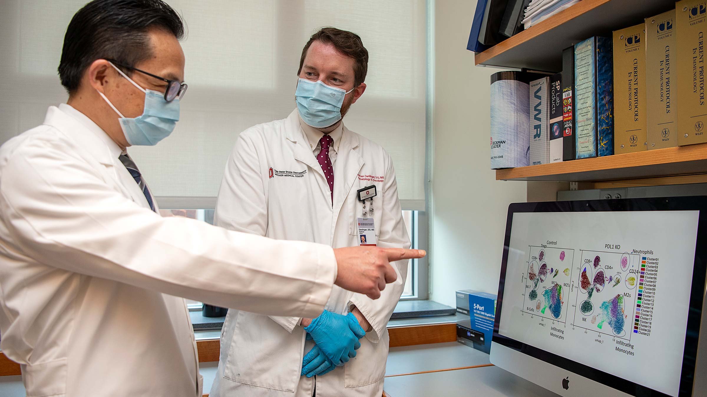 Yiping Yang, MD, PhD, reviewing images on a computer screen with a colleague