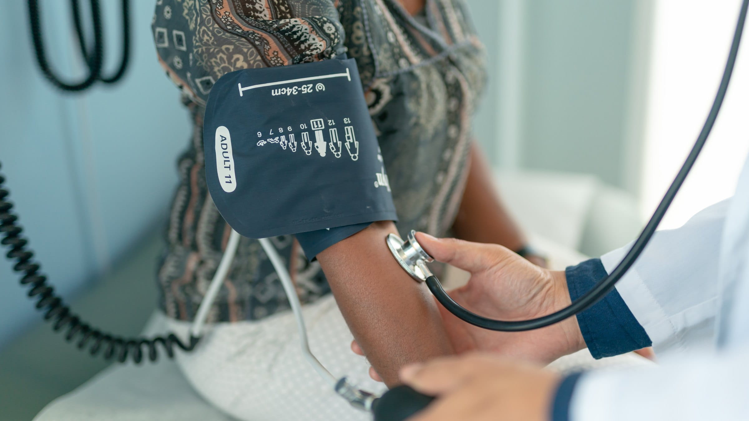 Nurse measuring patient’s blood pressure