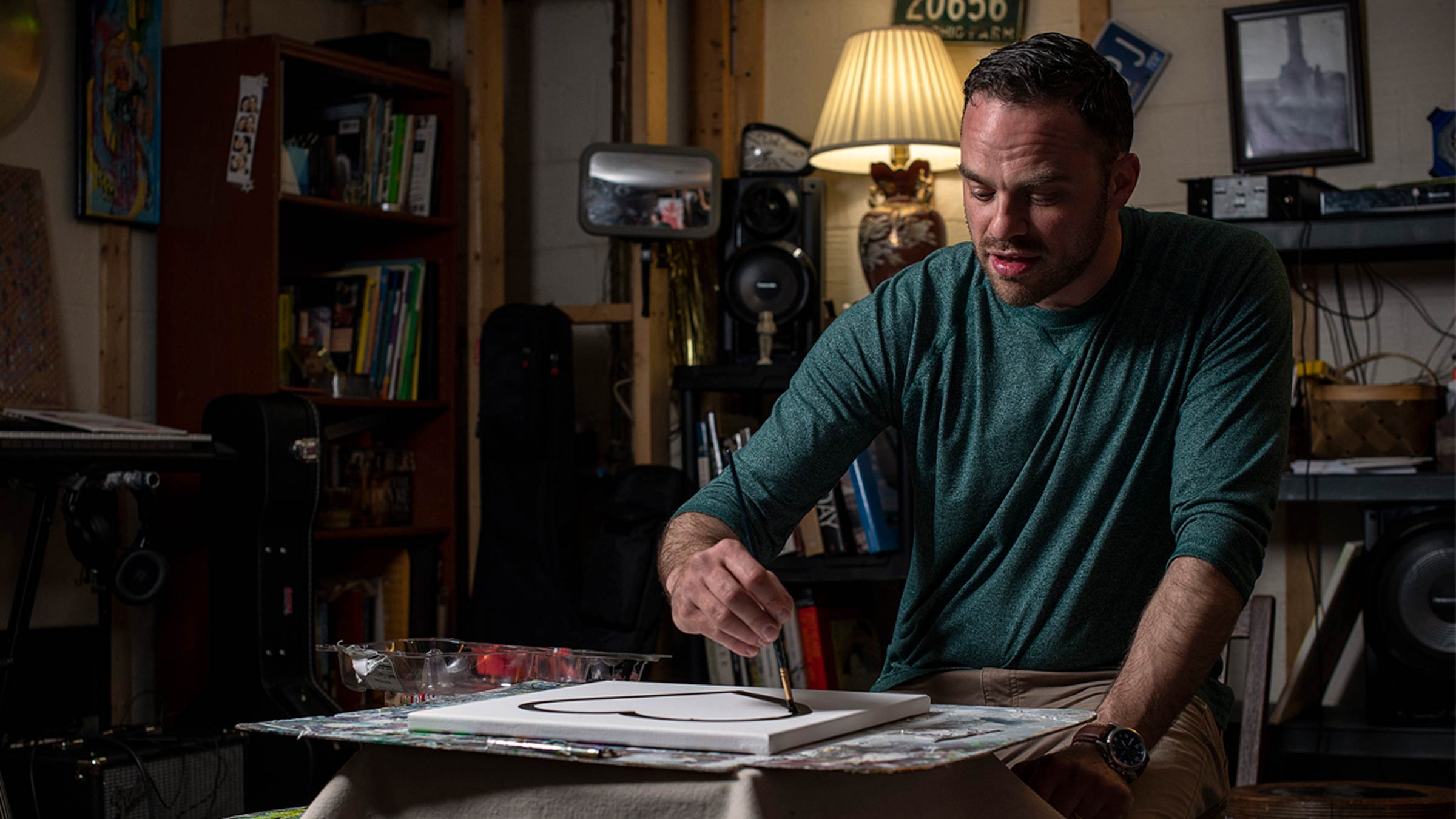 AJ Heckman painting in his studio