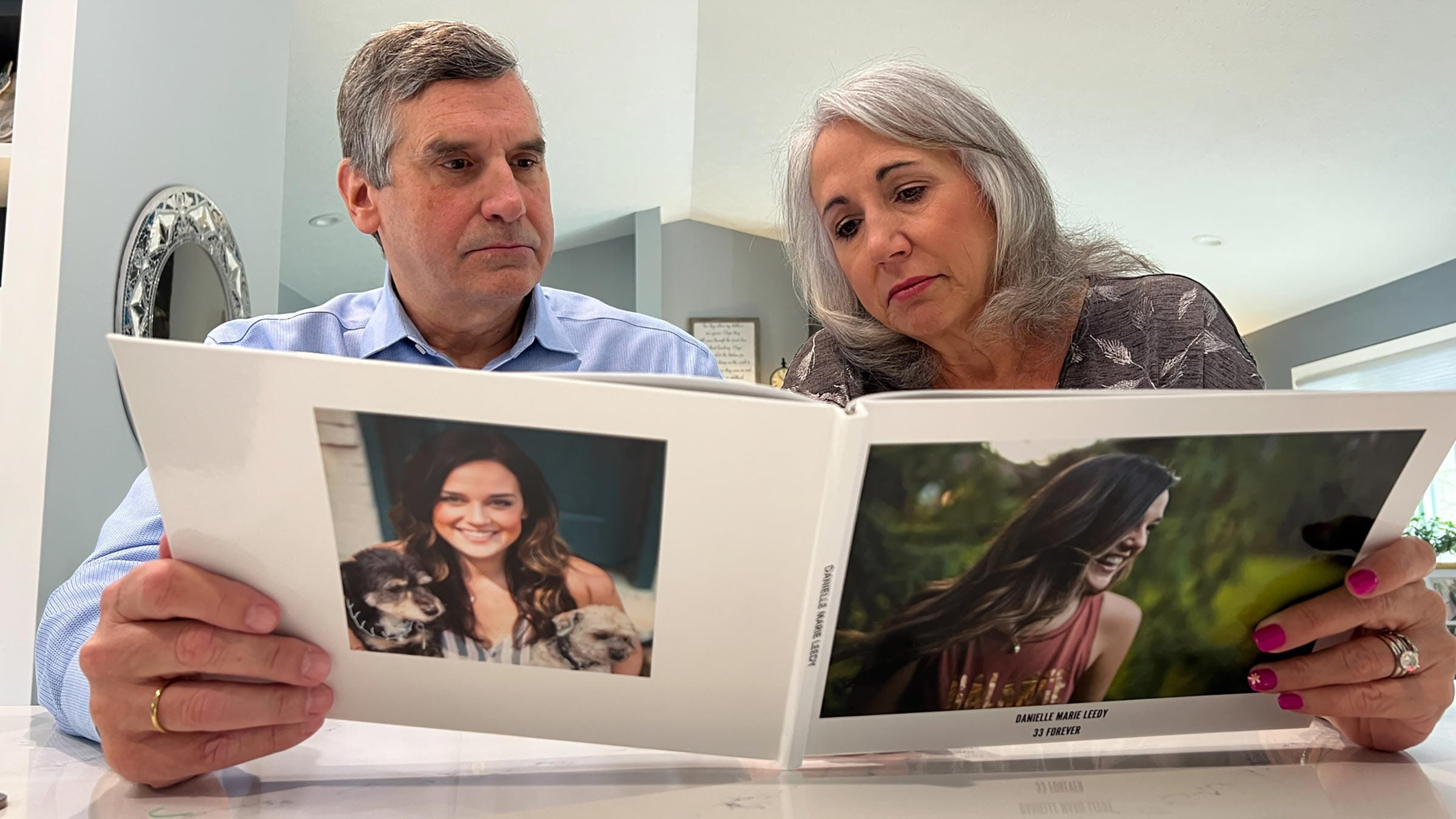 Donna and Jeff Heck looking at a photo book