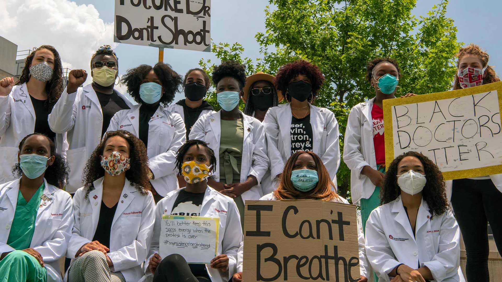 Group shot of doctors holding Black Lives Matter signs
