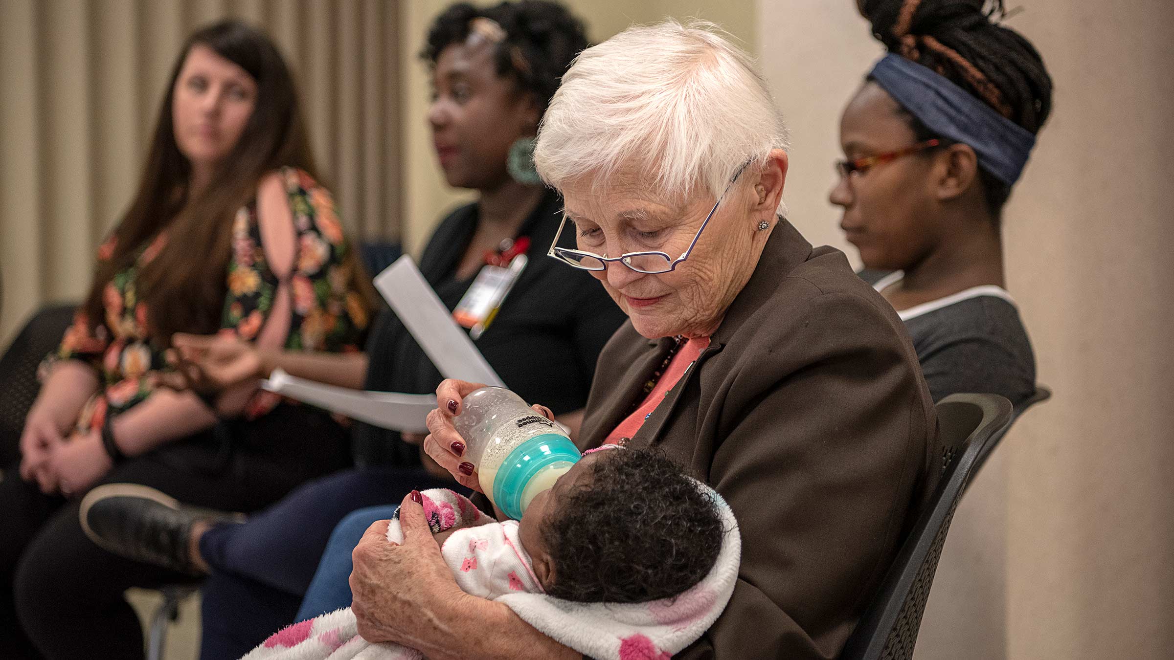 Pattricia Gabbe feeding a baby during a class