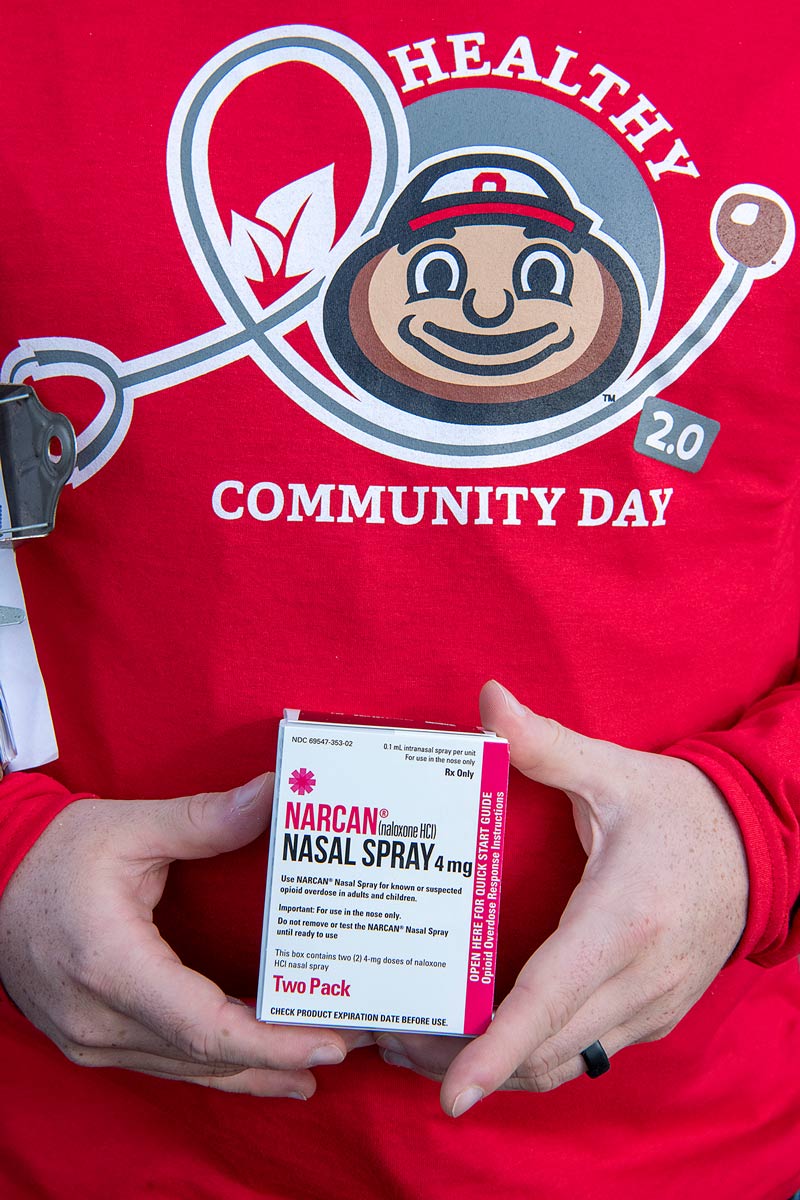 Hands holding a box of Narcan