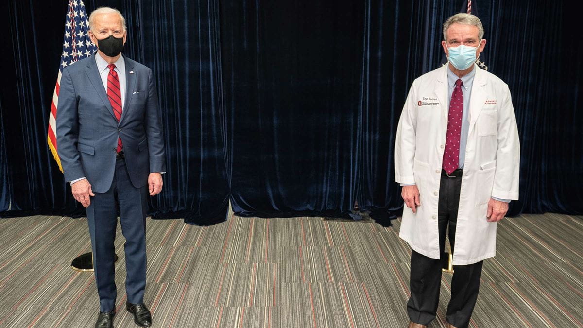Dr. Farrar standing with President Biden