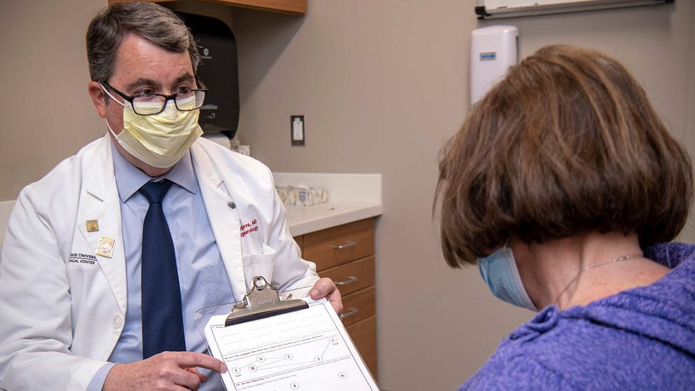 Neurologist Douglas Scharre, MD, showing a patient the SAGE test