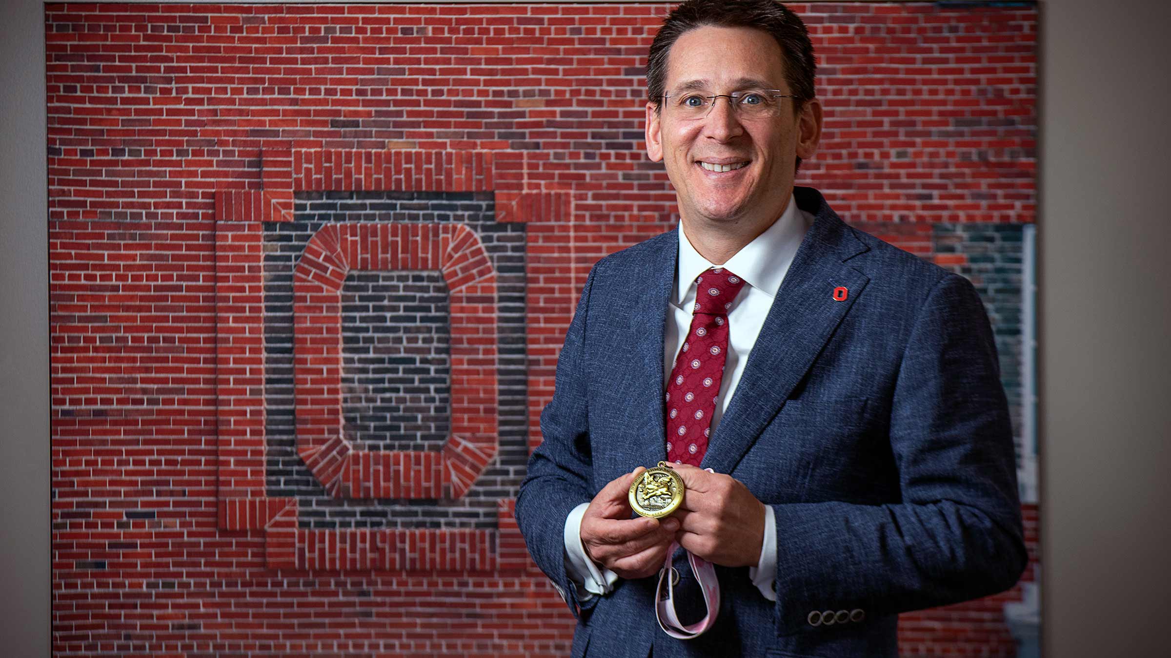 Dr. Pawlik holding a medal