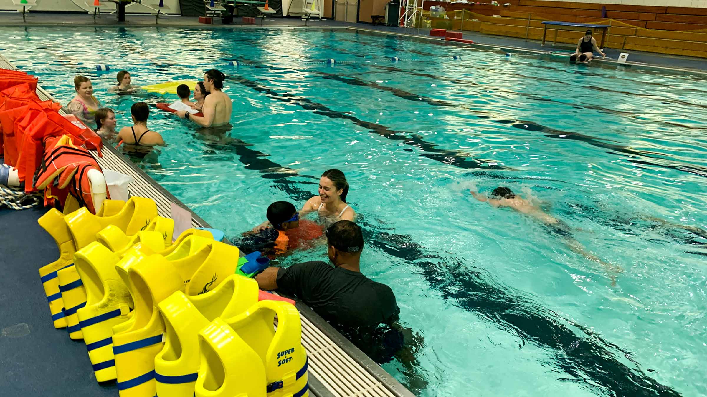 Teacher working with a child in a swimming pool