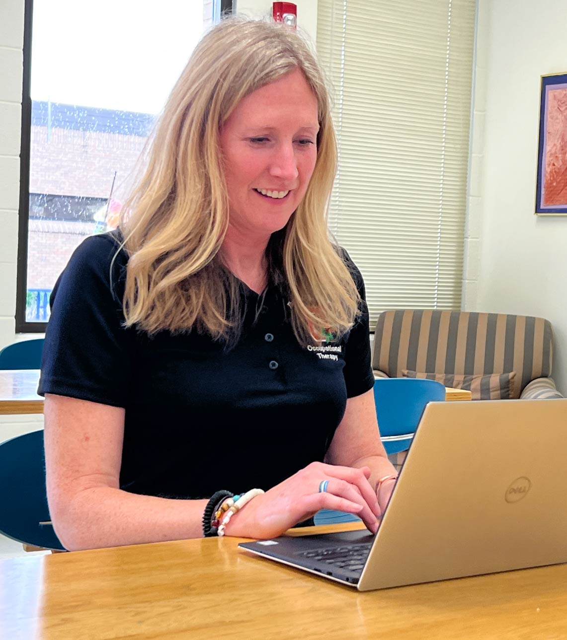 Dr. Erika Kemp working at her laptop