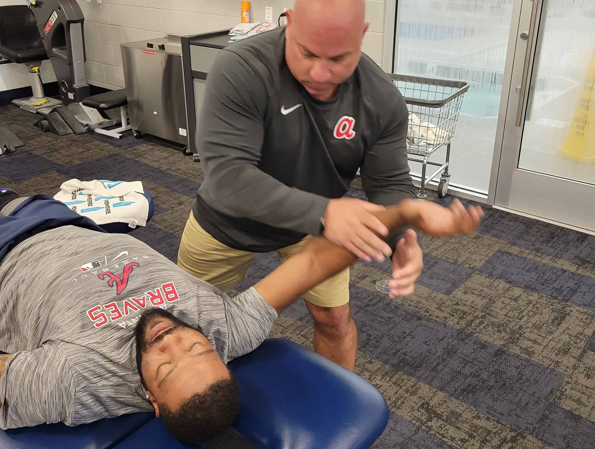 Atlanta Braves athlete with a physical therapist