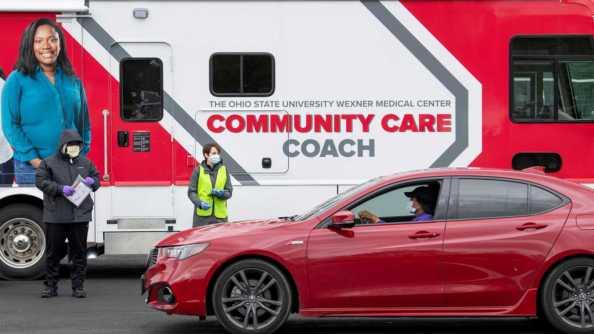 Car driving by the Community Care Coach bus