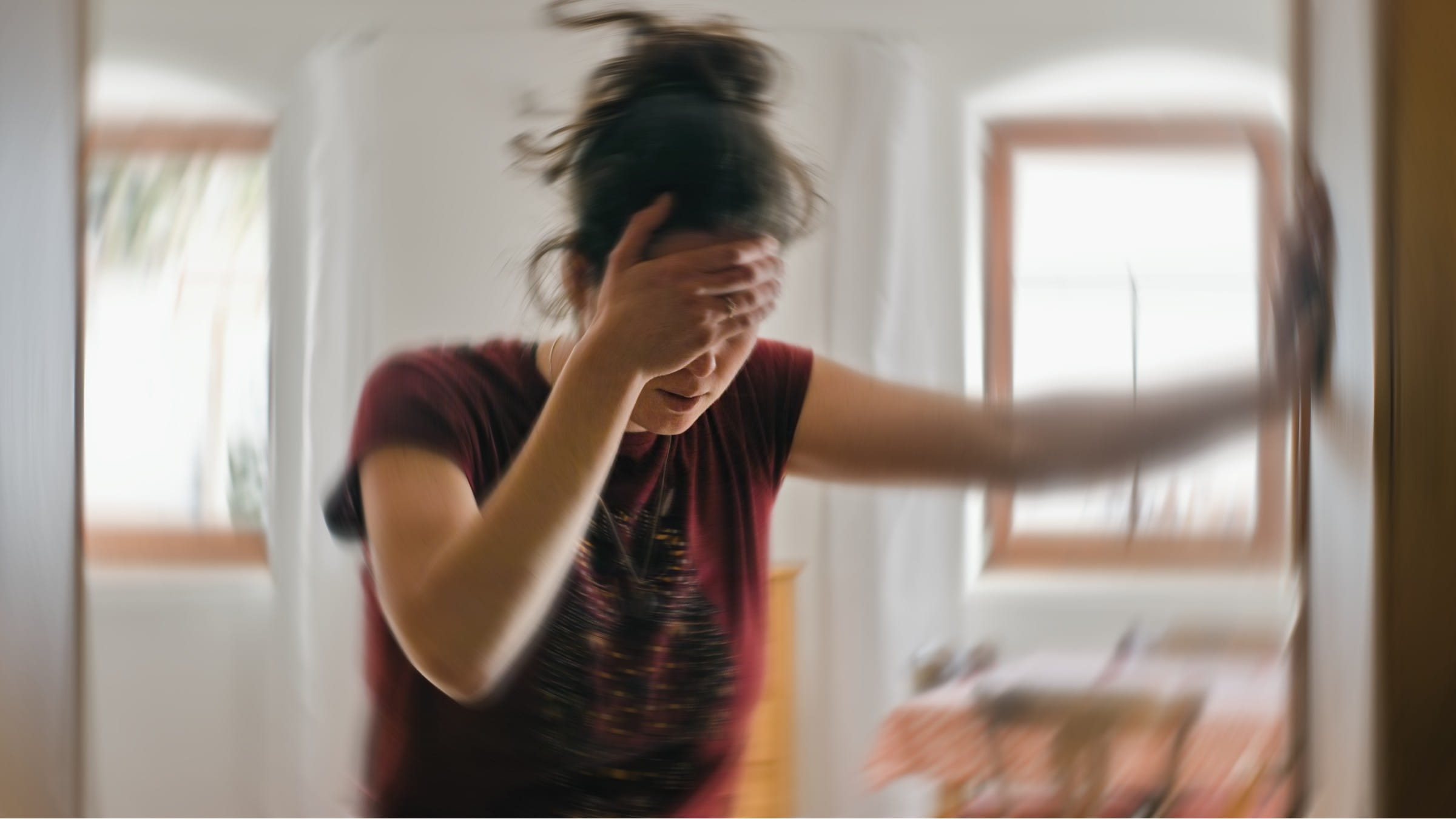 Woman holding her head feeling unsteady