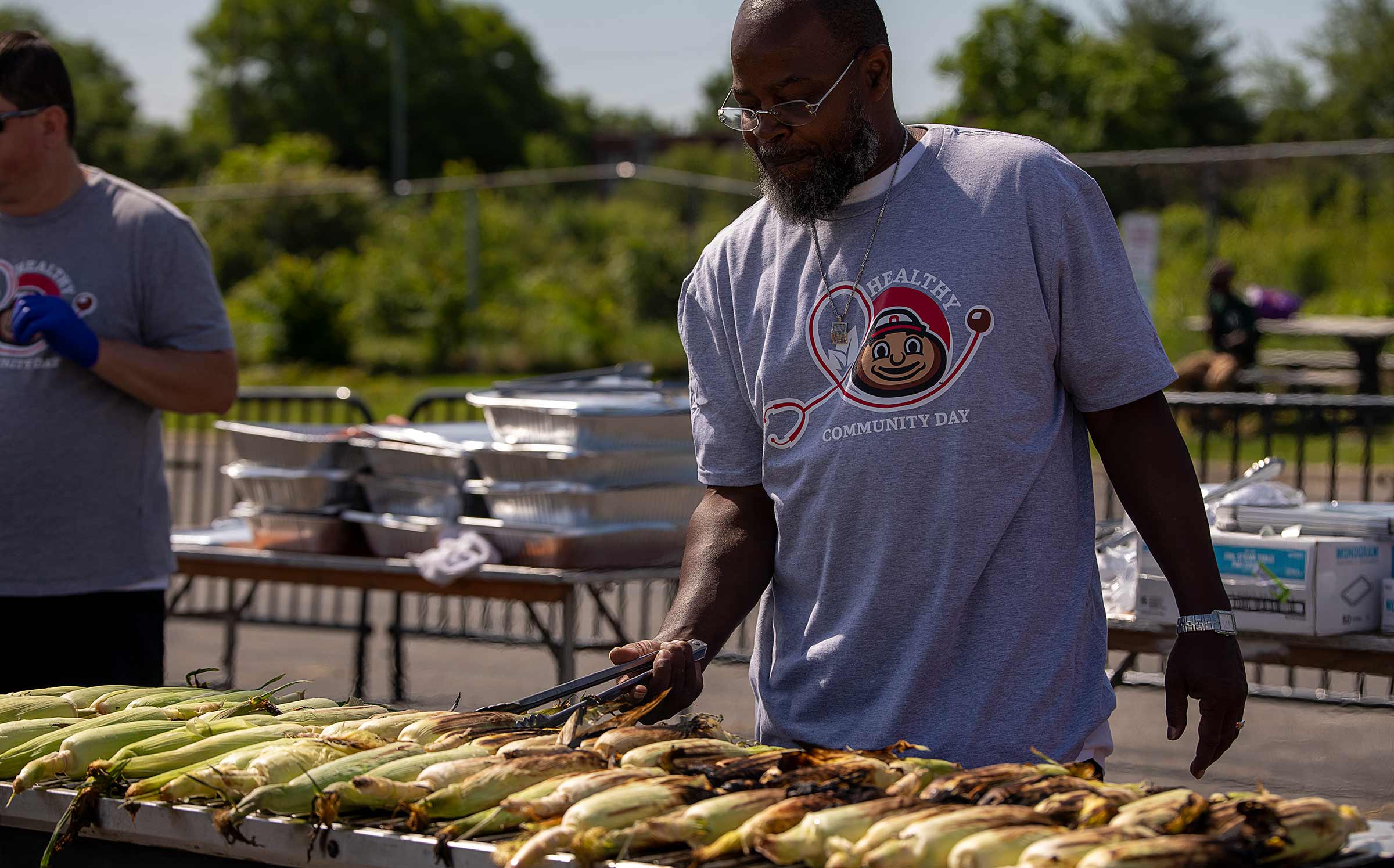 Man preparing grilled corn