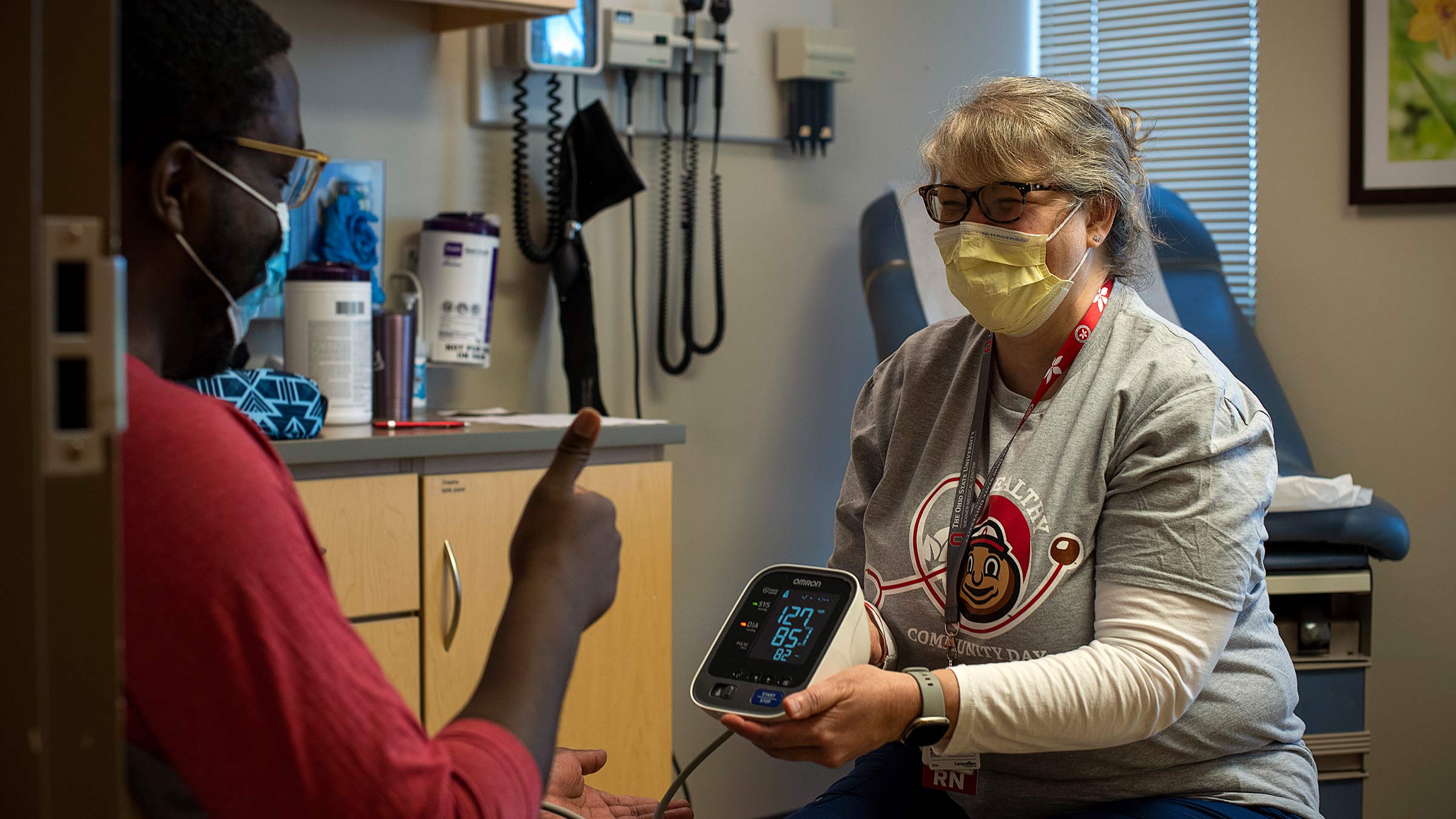 Nurse showing a patient his blood pressure readings