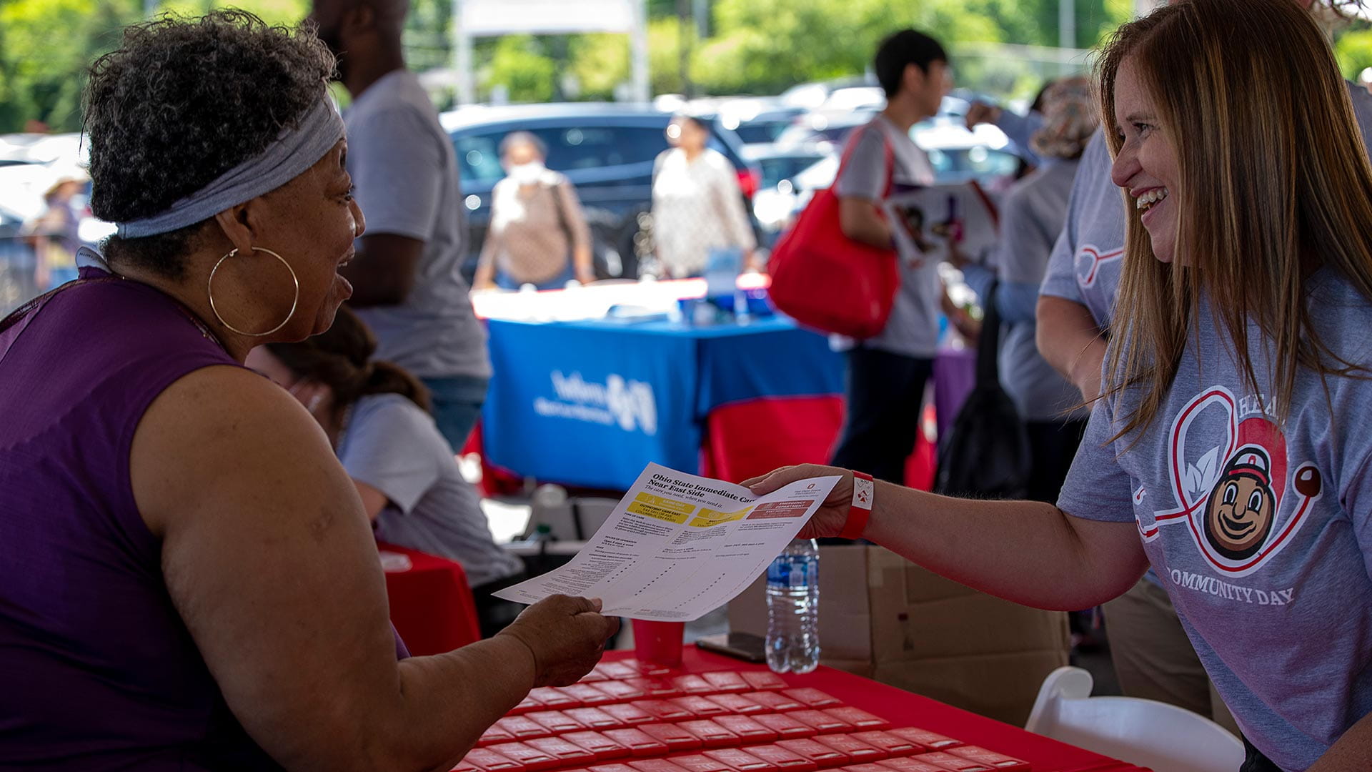 Ohio State volunteer talking to a woman